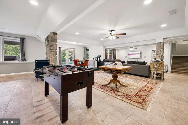 a living room with lots of furniture and kitchen view