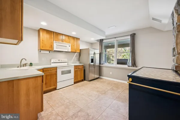 a kitchen with a stove a sink and a microwave
