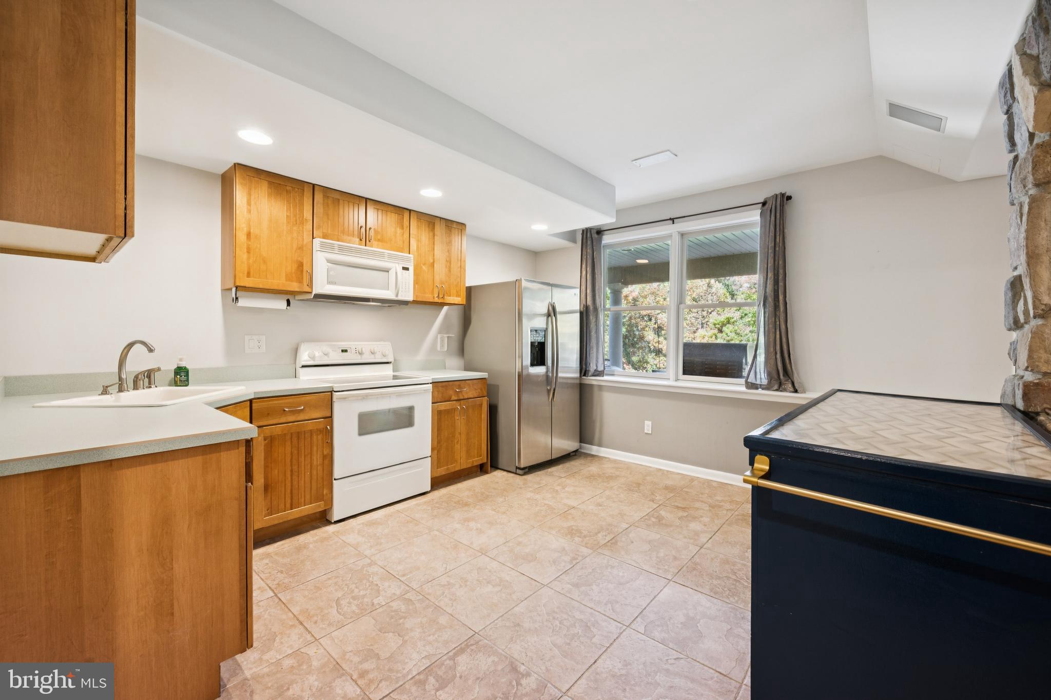 18 Lansbrook Court Sewell, NJ 08080 - Photo 31 of 44 a kitchen with a stove a sink and a microwave