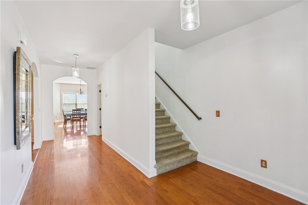 3154 Alhambra Circle Hampton, GA 30228 - Photo 11 of 33 a view of a hallway with wooden floor and staircase