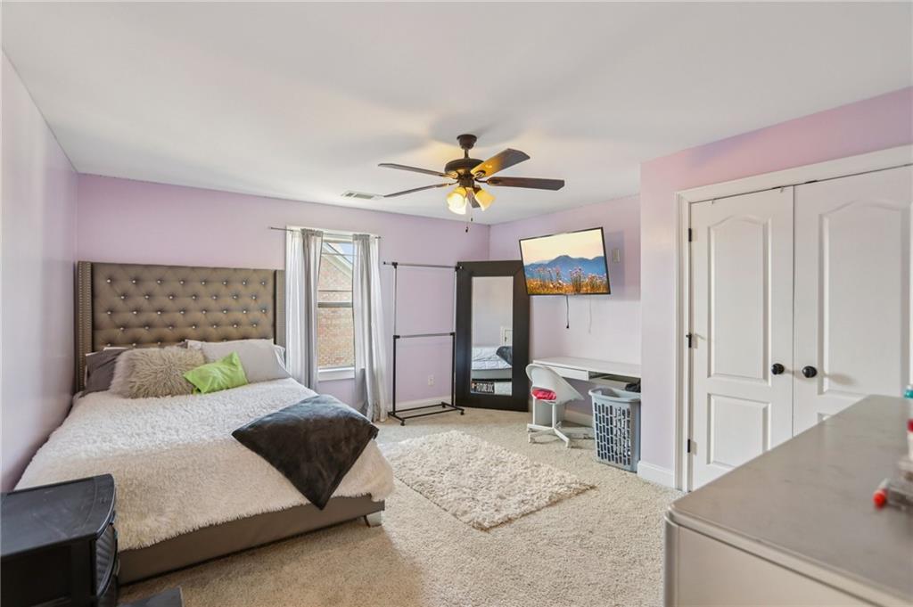 3154 Alhambra Circle Hampton, GA 30228 - Photo 14 of 33 a bedroom with a bed and a chandelier