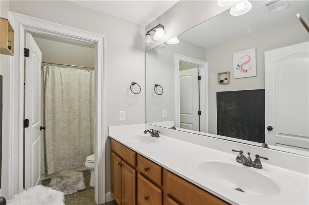 3154 Alhambra Circle Hampton, GA 30228 - Photo 15 of 33 a bathroom with a sink a toilet and shower