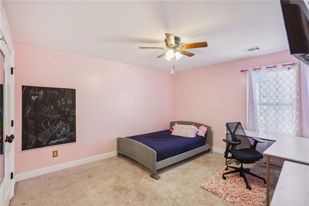 3154 Alhambra Circle Hampton, GA 30228 - Photo 19 of 33 a living room with furniture and a ceiling fan