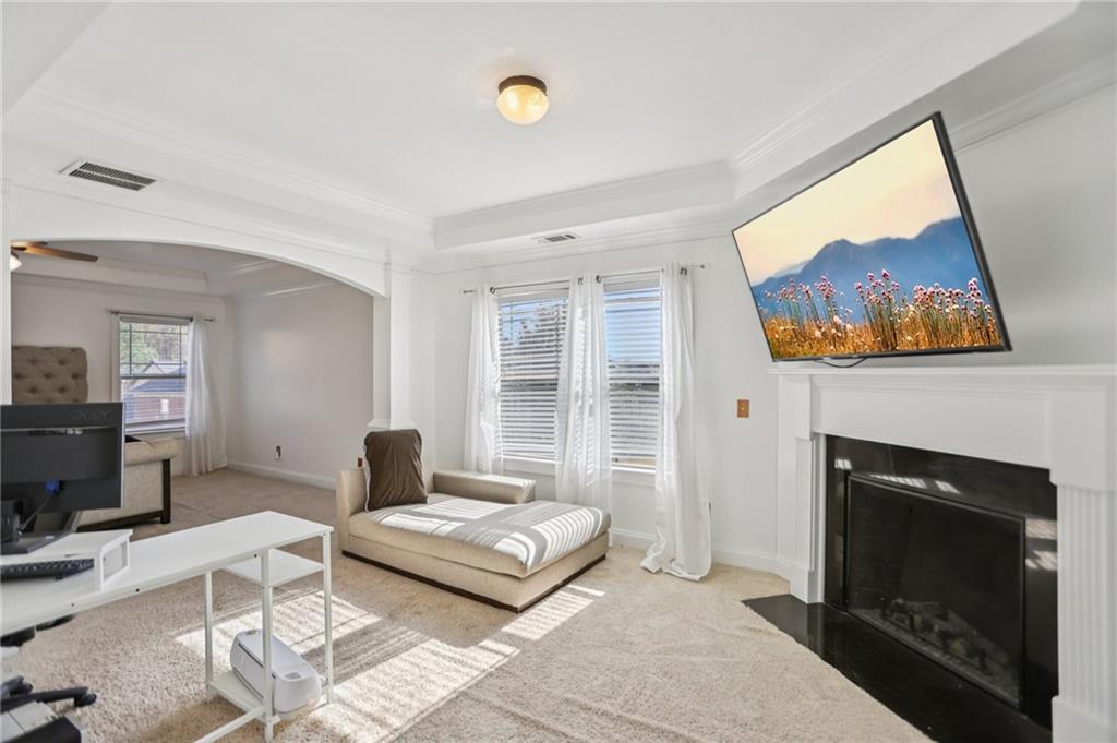 3154 Alhambra Circle Hampton, GA 30228 - Photo 20 of 33 a living room with furniture a flat screen tv and a fireplace