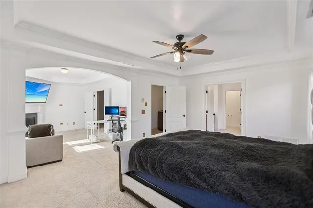 a living room with a bed furniture and a flat screen tv