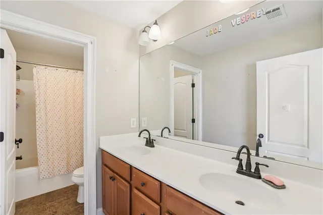 a bathroom with 2 sink and a mirror