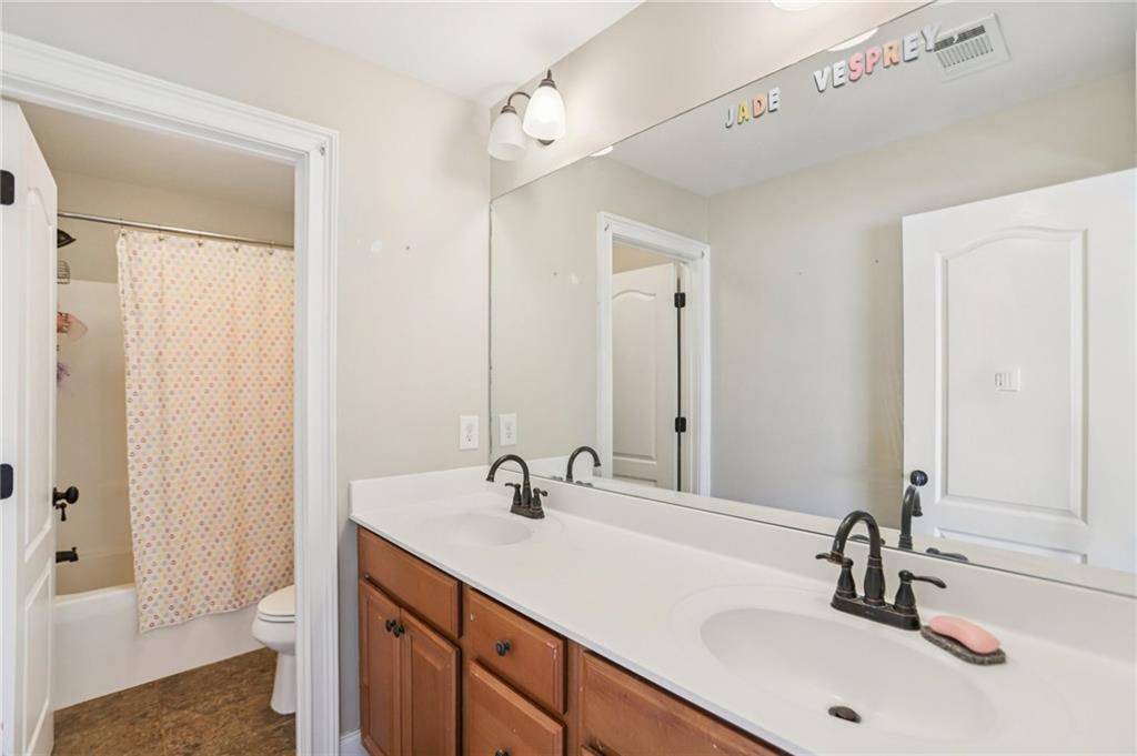 3154 Alhambra Circle Hampton, GA 30228 - Photo 24 of 33 a bathroom with 2 sink and a mirror
