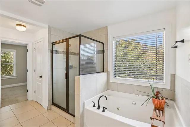 a bathroom with a bathtub and a shower