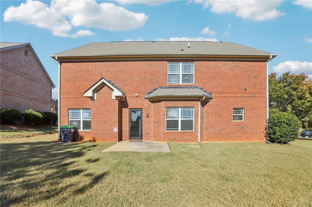 3154 Alhambra Circle Hampton, GA 30228 - Photo 28 of 33 a front view of a house with a yard