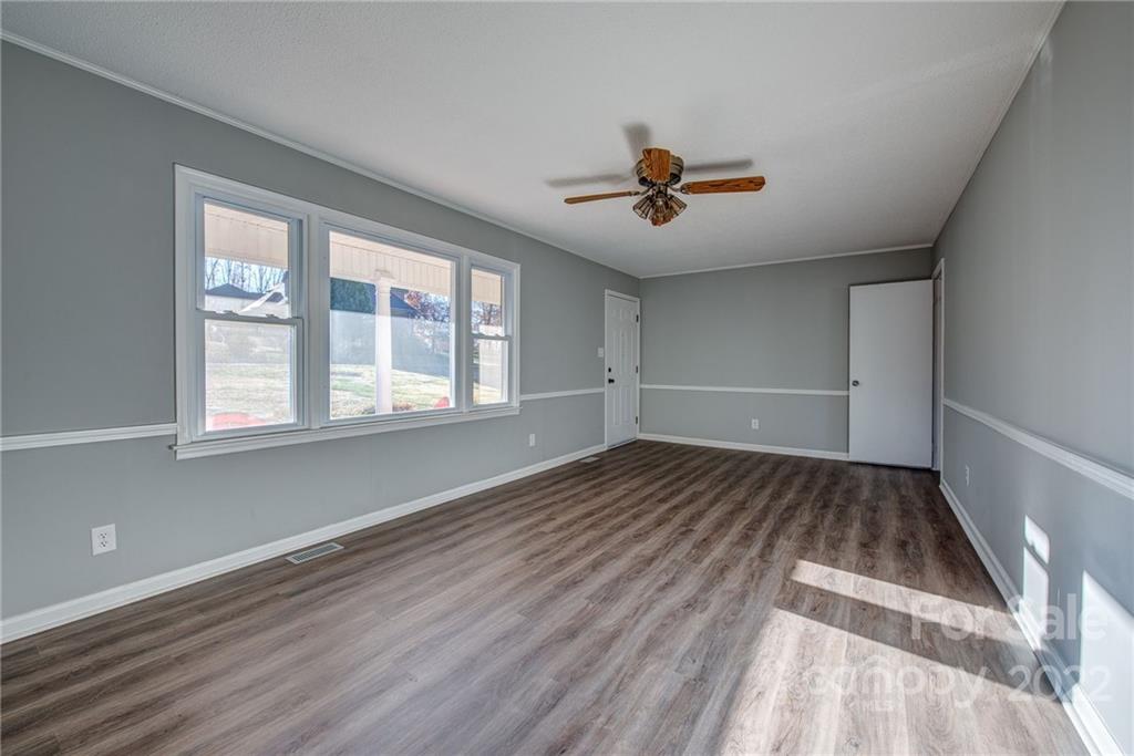 421 Ashebrook Park Road Dallas, NC 28034 - Photo 7 of 28 a view of empty room with wooden floor and fan