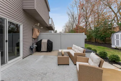 a view of backyard with outdoor seating and trees