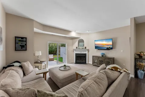a living room with furniture fireplace and a flat screen tv