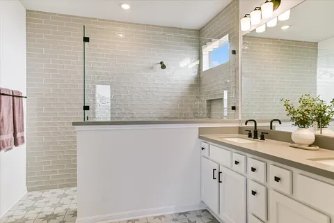a en suite bathroom with a double sink and mirror