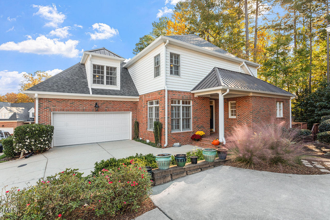 7342 Fontana Ridge Lane Raleigh, NC 27613 - Photo 1 of 26 a front view of a house with garden