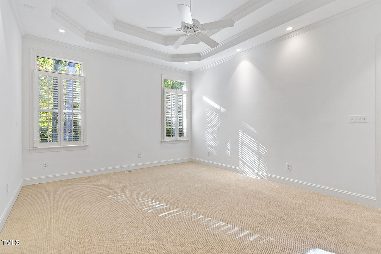7342 Fontana Ridge Lane Raleigh, NC 27613 - Photo 14 of 26 an empty room with windows and chandelier fan