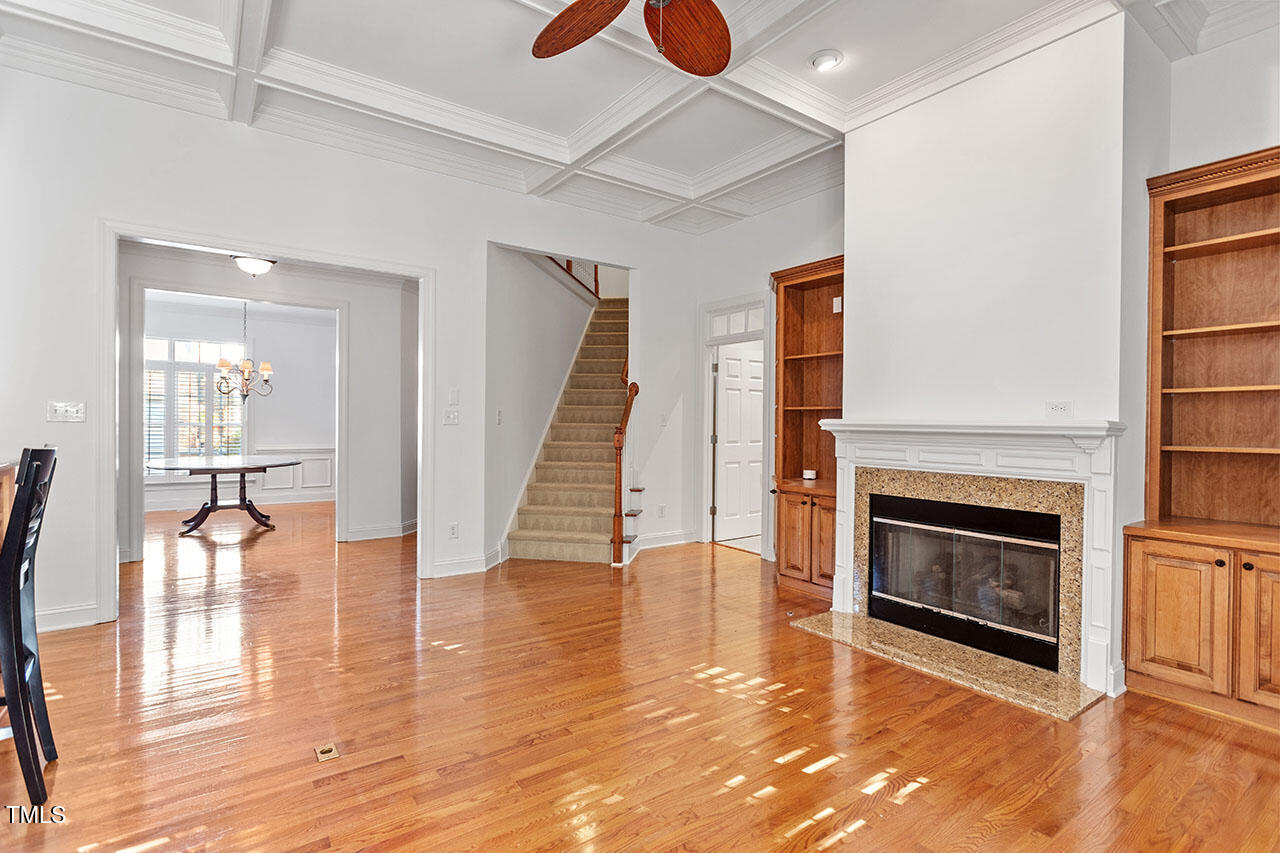 7342 Fontana Ridge Lane Raleigh, NC 27613 - Photo 5 of 26 an empty room with wooden floor fireplace and windows