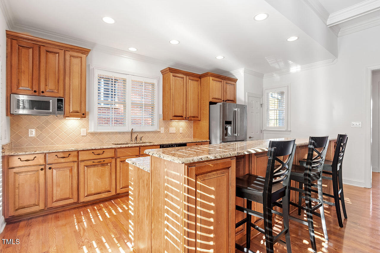 7342 Fontana Ridge Lane Raleigh, NC 27613 - Photo 10 of 26 a kitchen with stainless steel appliances granite countertop a stove a sink and a refrigerator