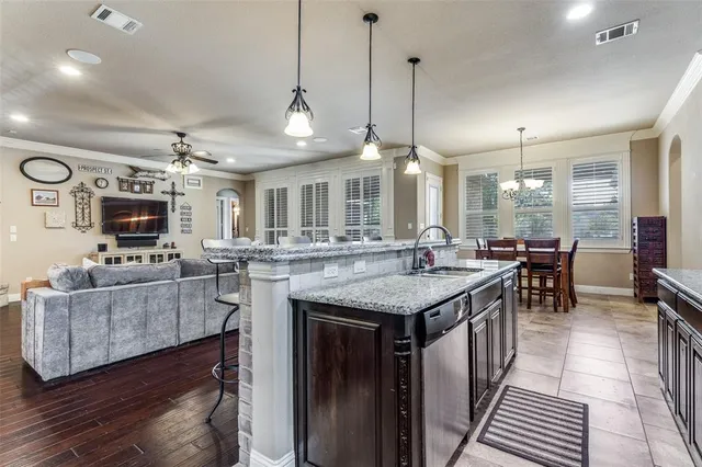 a kitchen with stainless steel appliances granite countertop a stove and a wooden floors