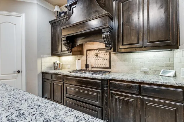 a kitchen with granite countertop stainless steel appliances and cabinets