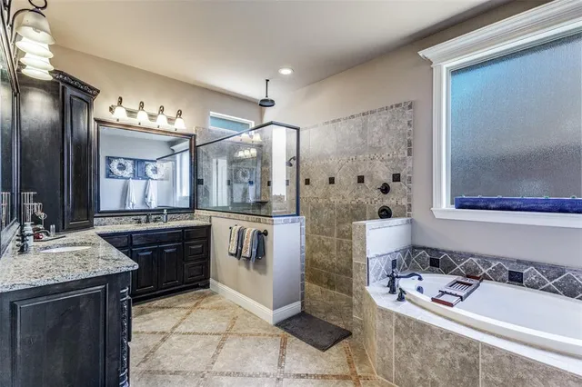 a bathroom with a bathtub sink and mirror