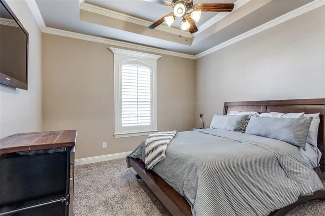 a bedroom with a bed and a television