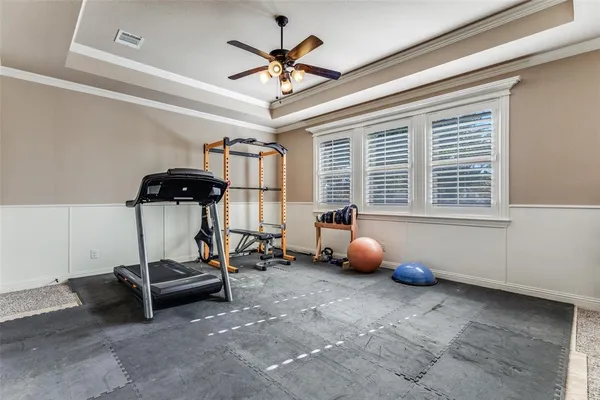 a room with gym equipment and windows