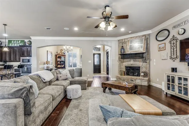 a living room with furniture kitchen view and a fireplace