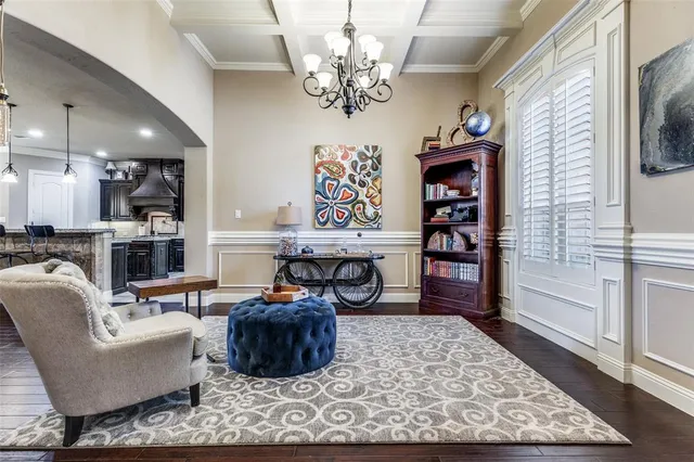a living room with fireplace furniture and a rug