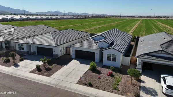 an aerial view of a house with a garden and lake view