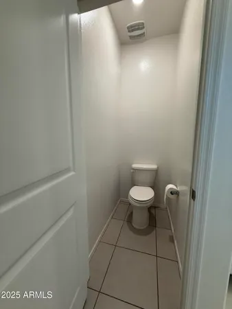 a white toilet sitting next to a shower
