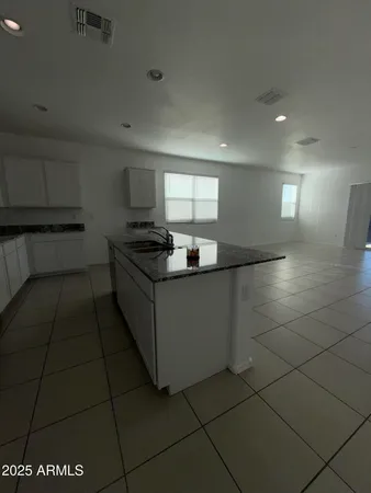 a large kitchen with stainless steel appliances lots of counter space and a sink