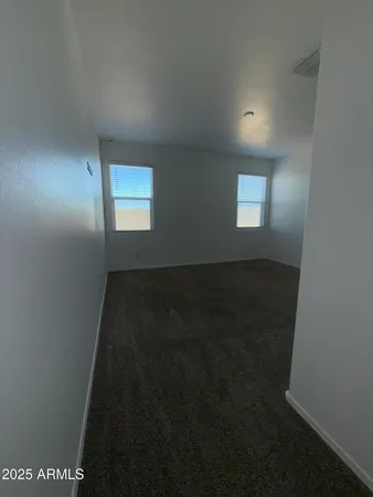 a view of an empty room and a window