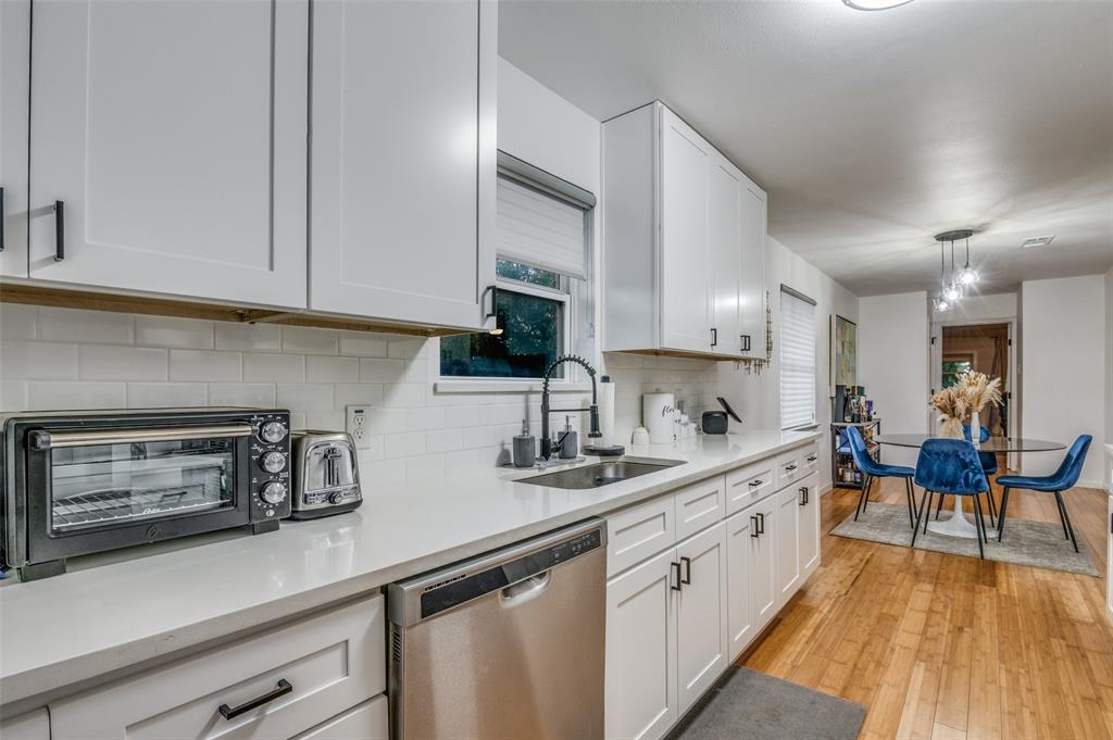 11211 McCree Road Dallas, TX 75238 - Photo 12 of 29 a kitchen with white cabinets sink and white appliances