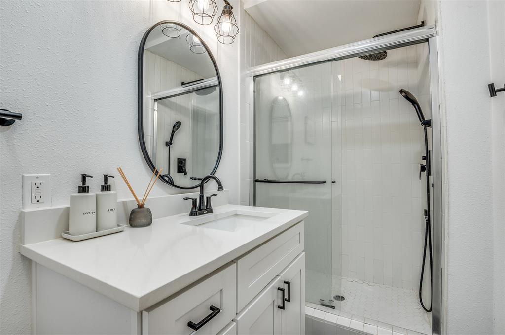 11211 McCree Road Dallas, TX 75238 - Photo 20 of 29 a bathroom with a sink a vanity and a mirror