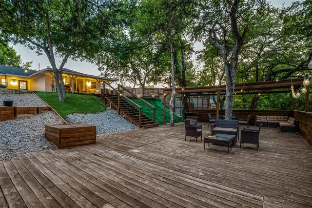 a front view of a house with garden and sitting area