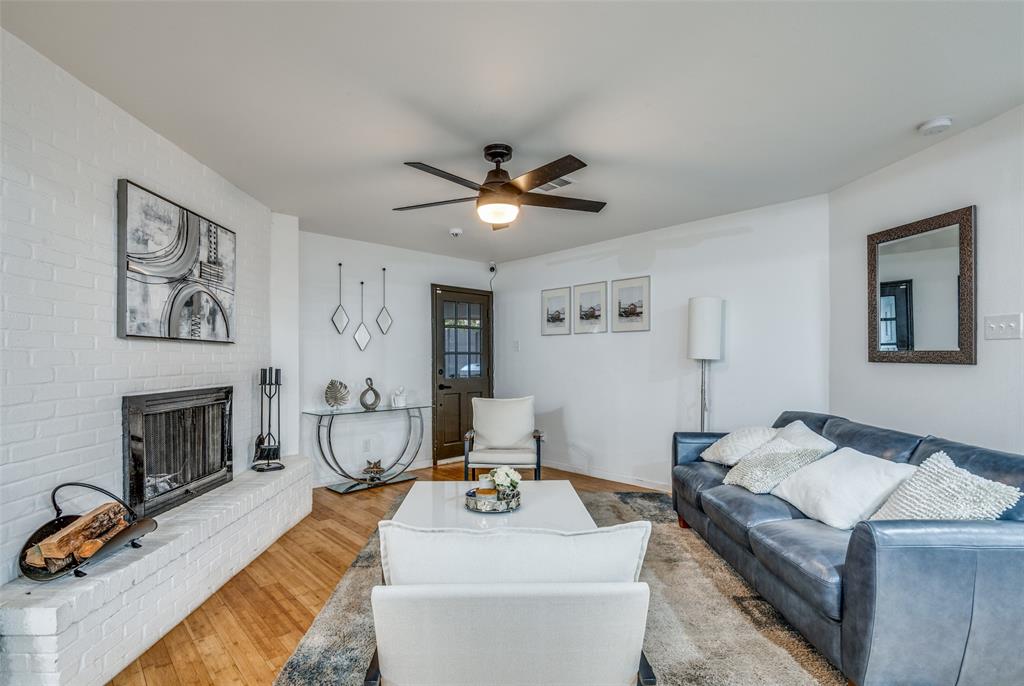 11211 McCree Road Dallas, TX 75238 - Photo 3 of 29 a living room with furniture and a fireplace