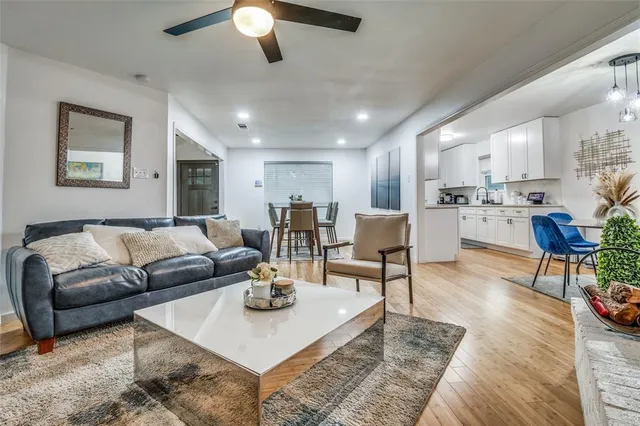 a living room with furniture and a kitchen view