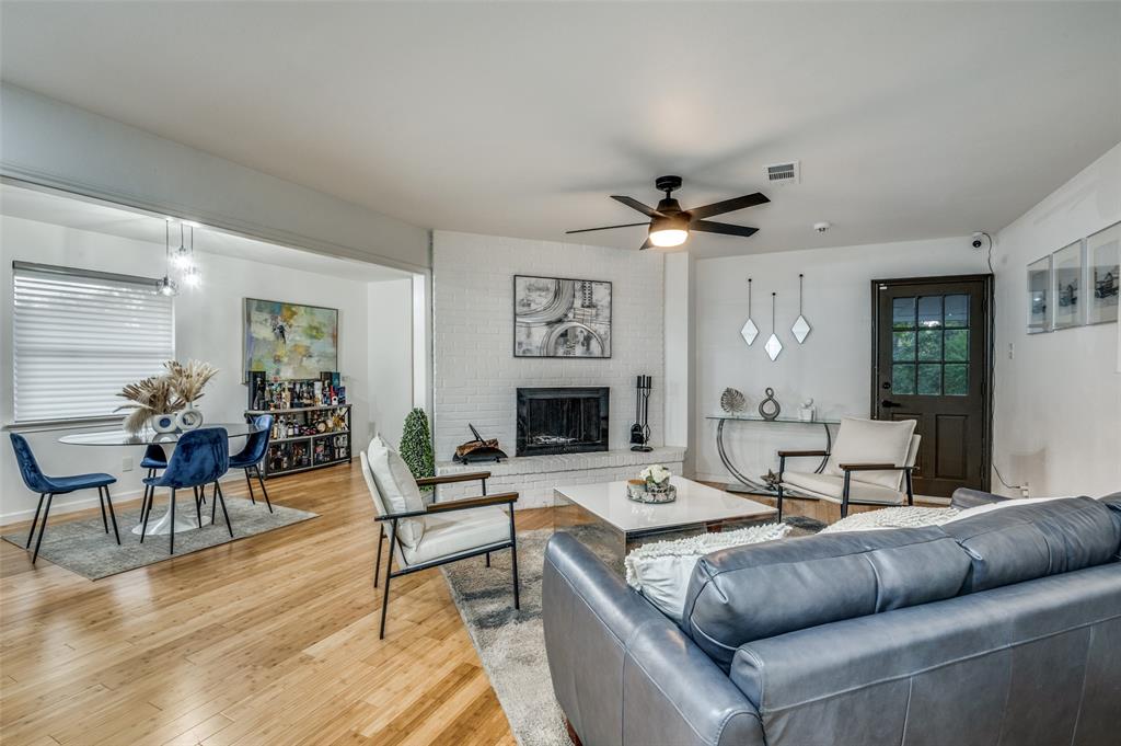 11211 McCree Road Dallas, TX 75238 - Photo 5 of 29 a living room with furniture a fireplace and a chandelier