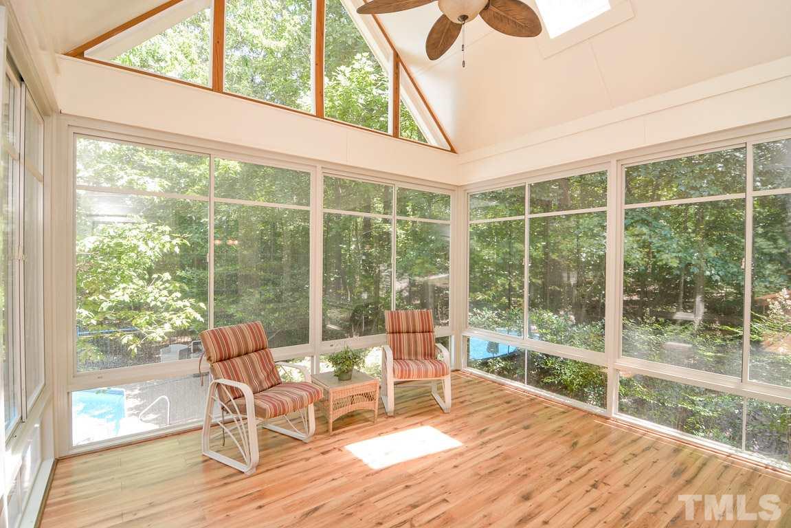 1408 Silverling Way Raleigh, NC 27613 - Photo 22 of 25 a living room with a floor to ceiling window chairs and wooden floor