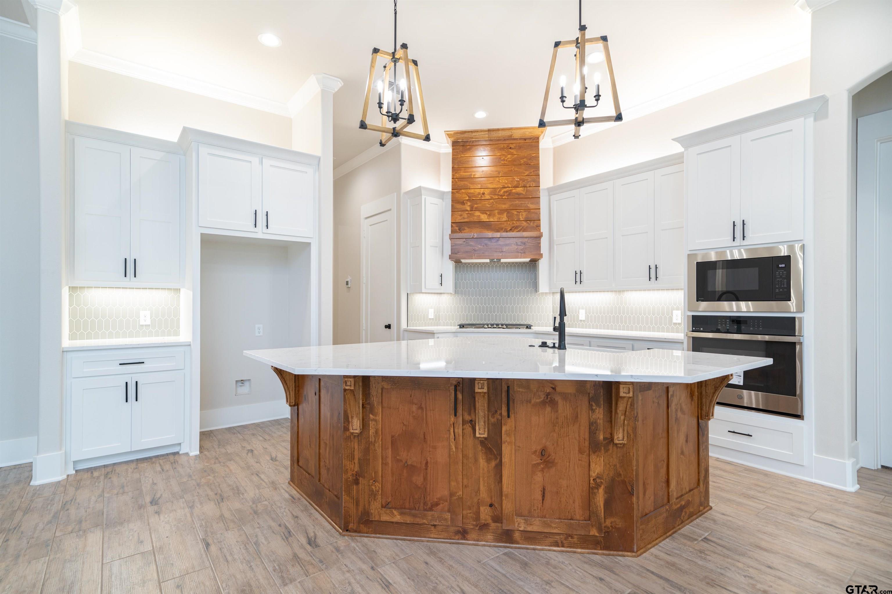 3910 Hidden Hills Circle Longview, TX 75605 - Photo 11 of 39 a kitchen with kitchen island granite countertop a sink and refrigerator