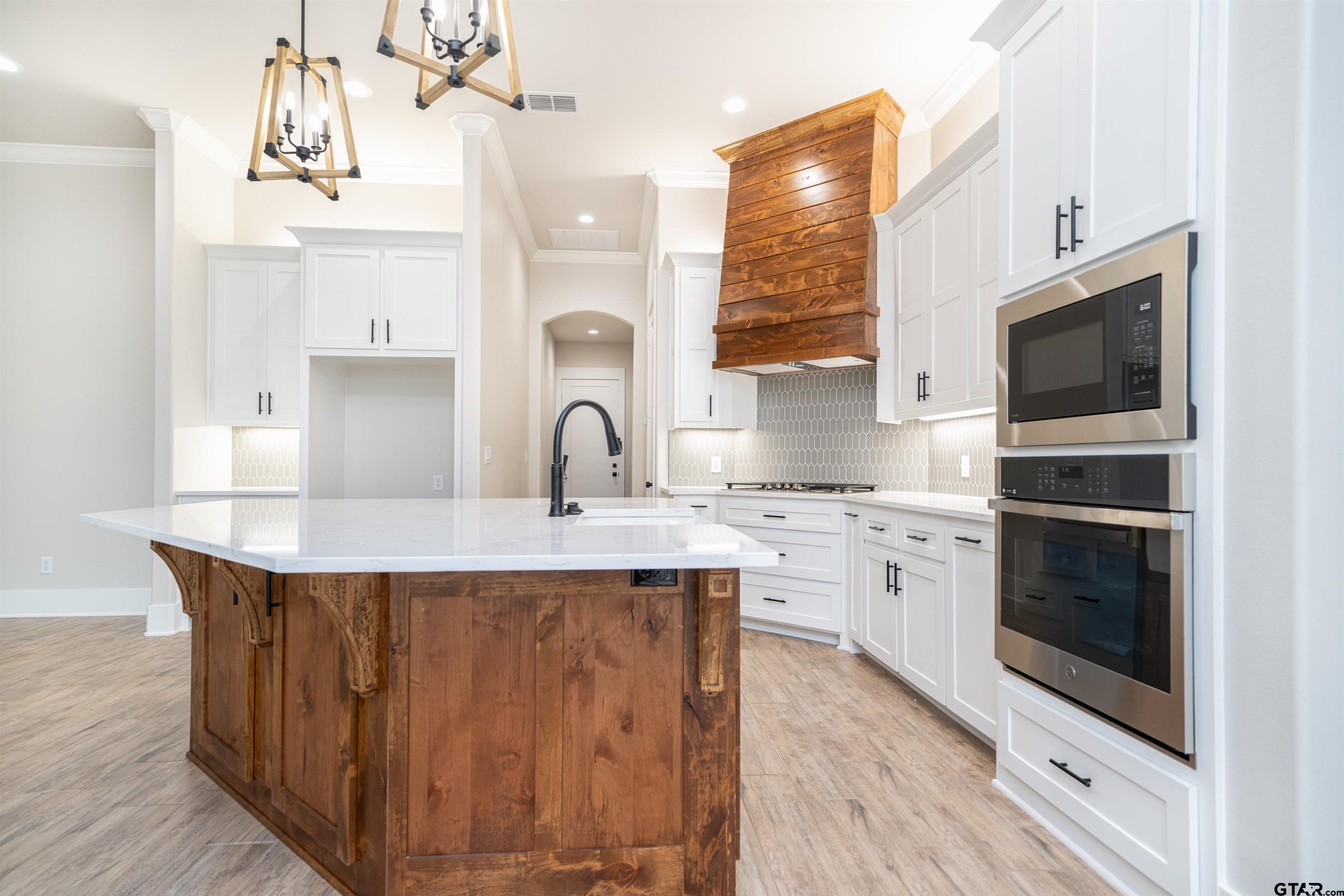 3910 Hidden Hills Circle Longview, TX 75605 - Photo 12 of 39 a kitchen with stainless steel appliances a sink stove and cabinets