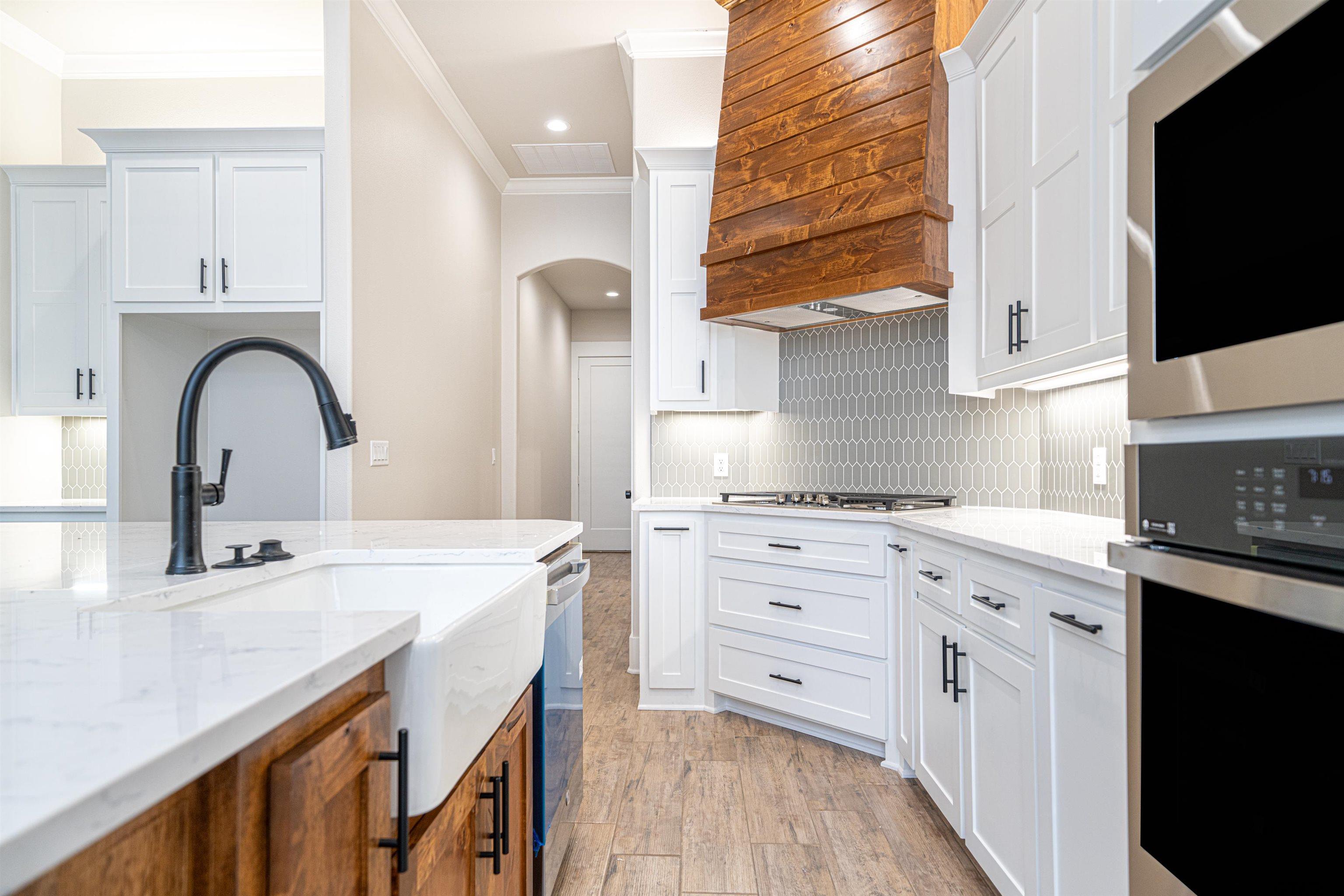 3910 Hidden Hills Circle Longview, TX 75605 - Photo 13 of 39 a kitchen with granite countertop white cabinets and appliances