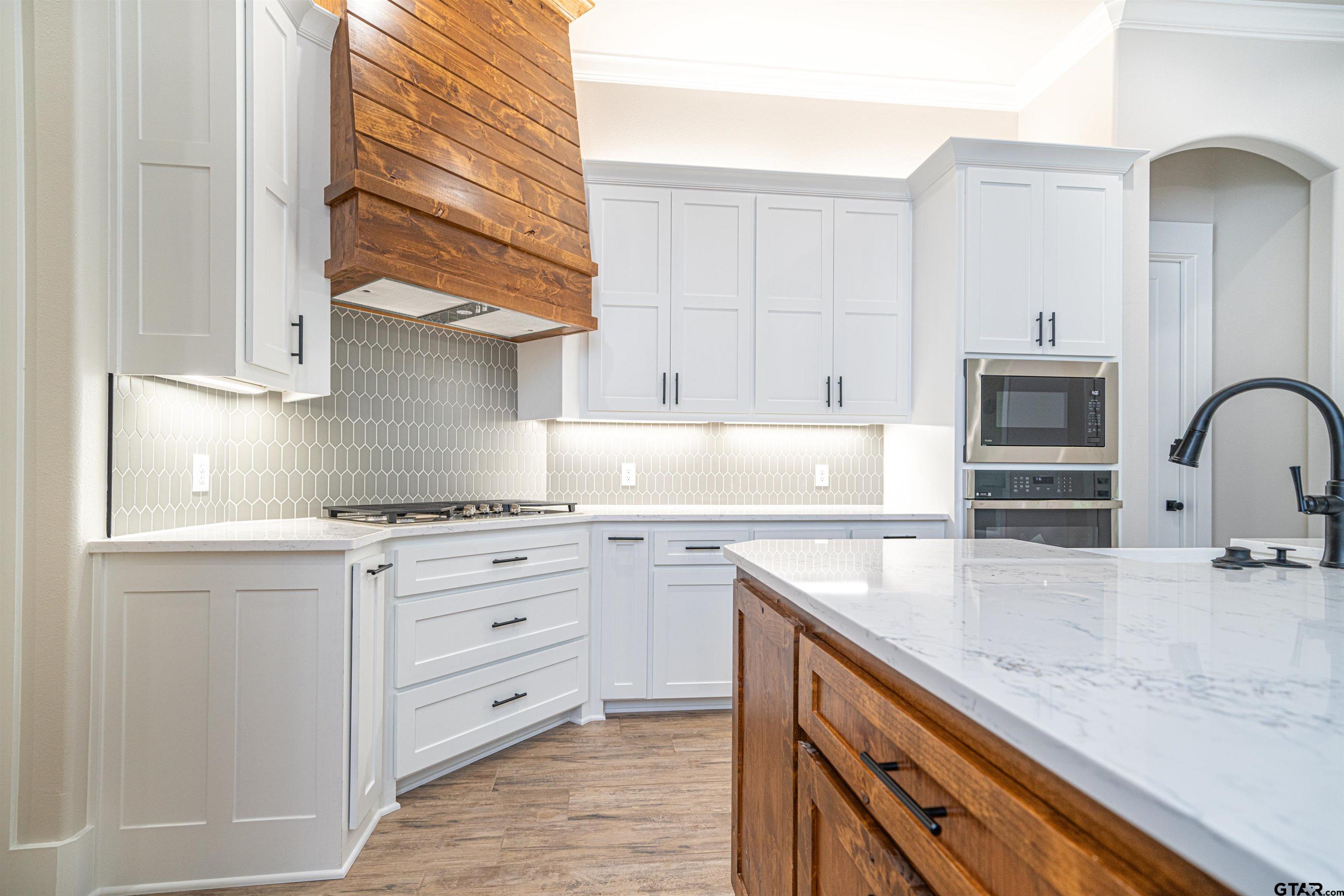 3910 Hidden Hills Circle Longview, TX 75605 - Photo 14 of 39 a kitchen with granite countertop a sink stainless steel appliances and cabinets