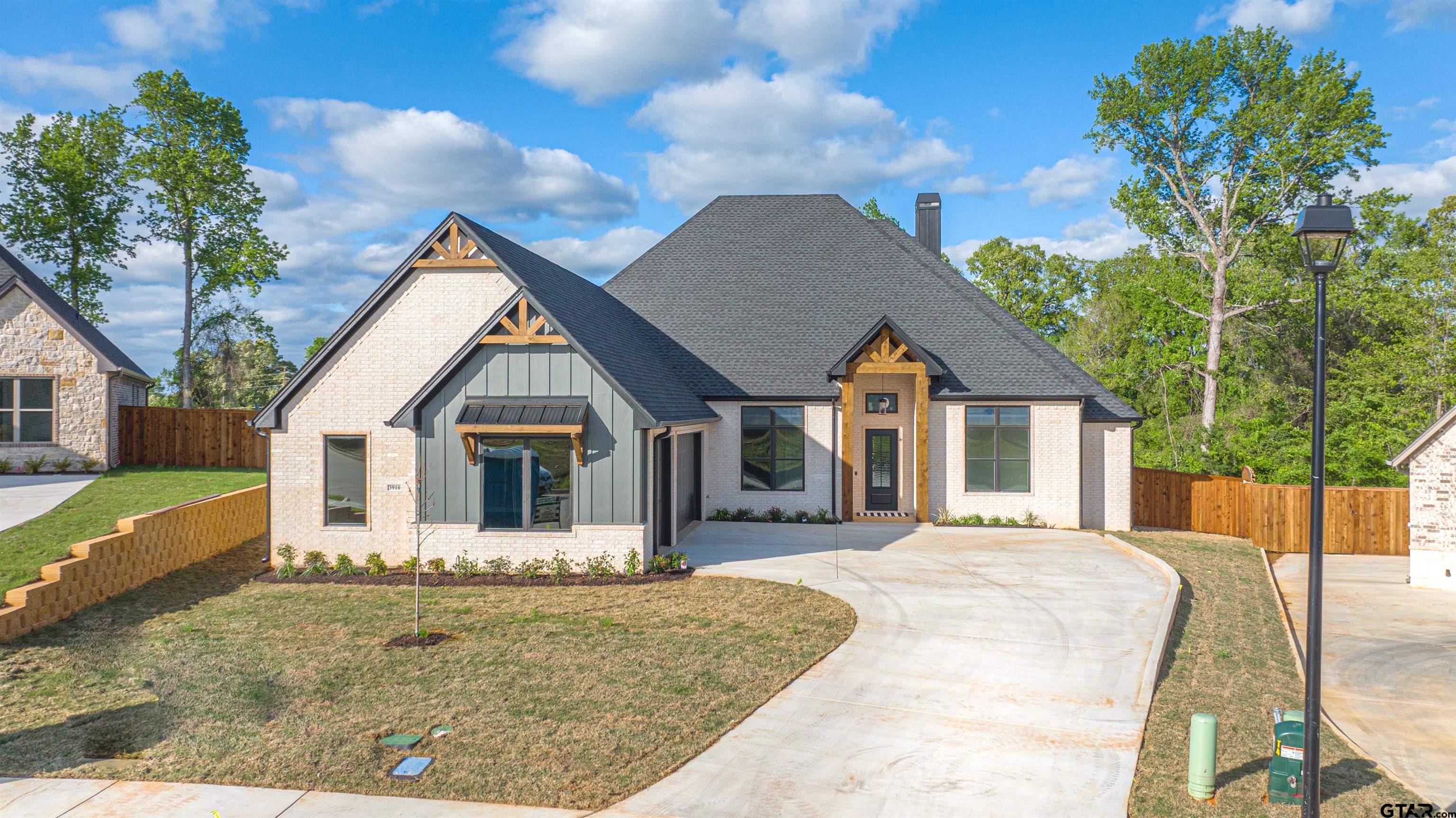 3910 Hidden Hills Circle Longview, TX 75605 - Photo 2 of 39 a front view of a house with a yard and potted plants