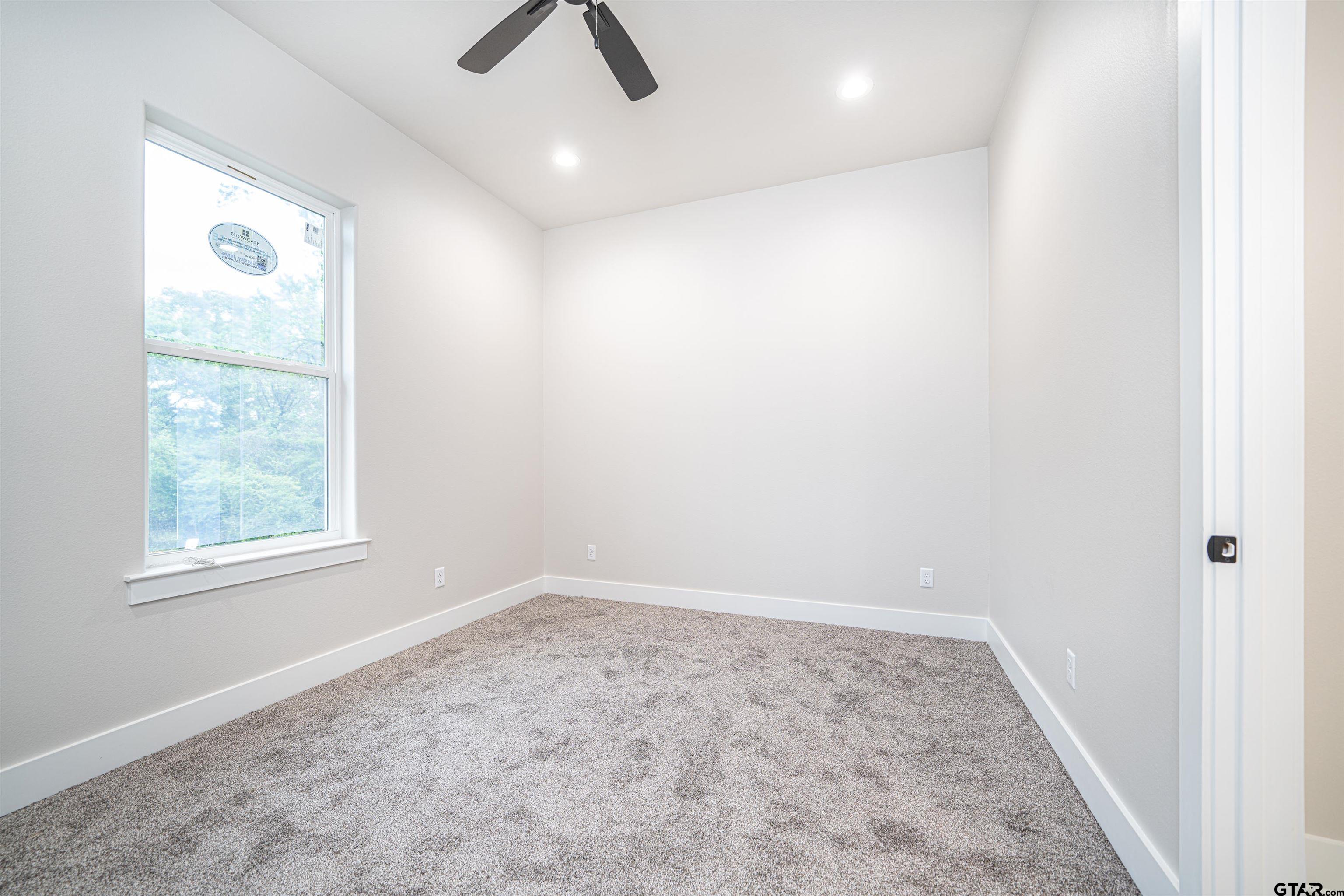 3910 Hidden Hills Circle Longview, TX 75605 - Photo 27 of 39 an empty room with windows