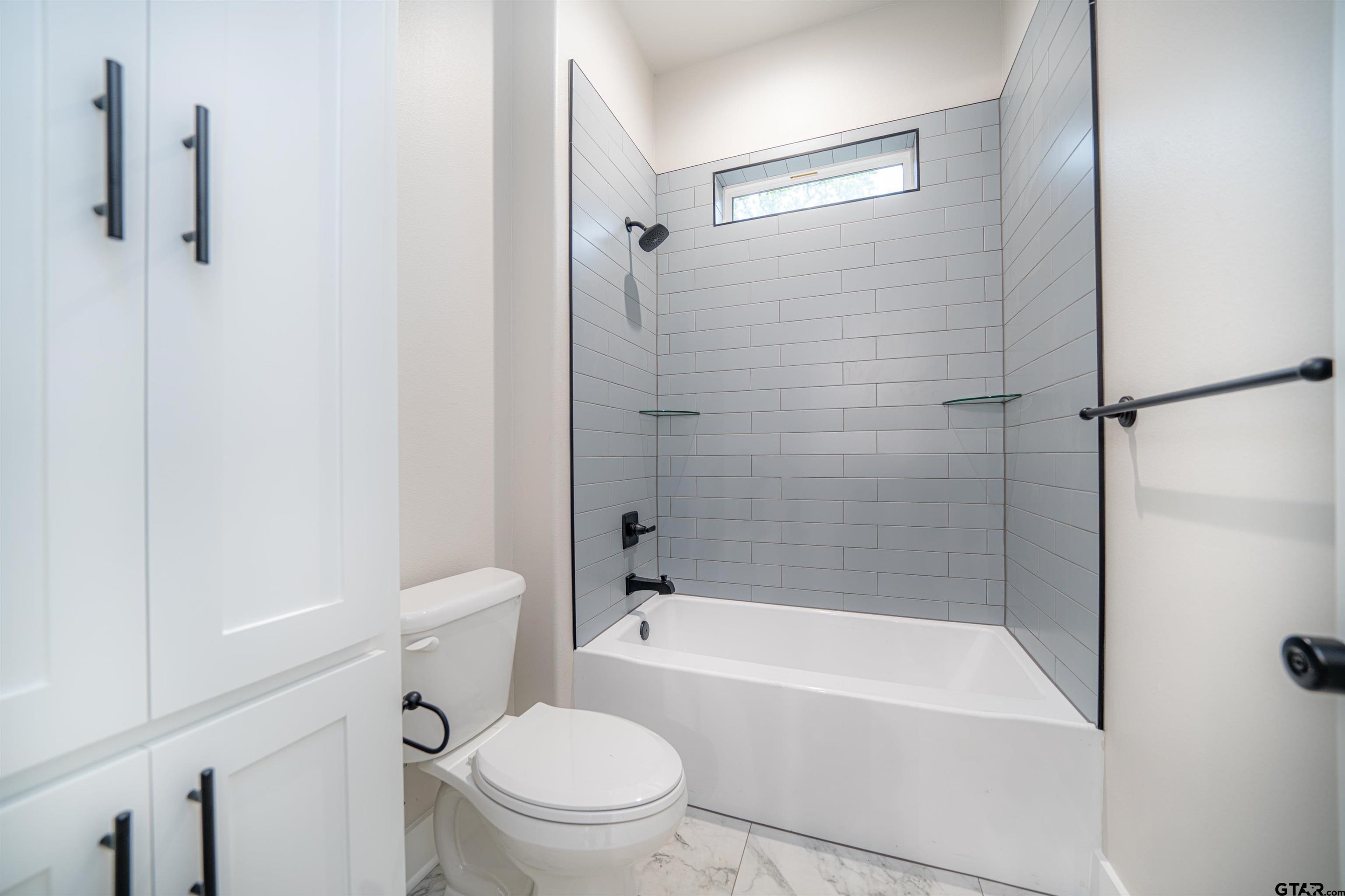 3910 Hidden Hills Circle Longview, TX 75605 - Photo 29 of 39 a bathroom with a bathtub toilet and shower