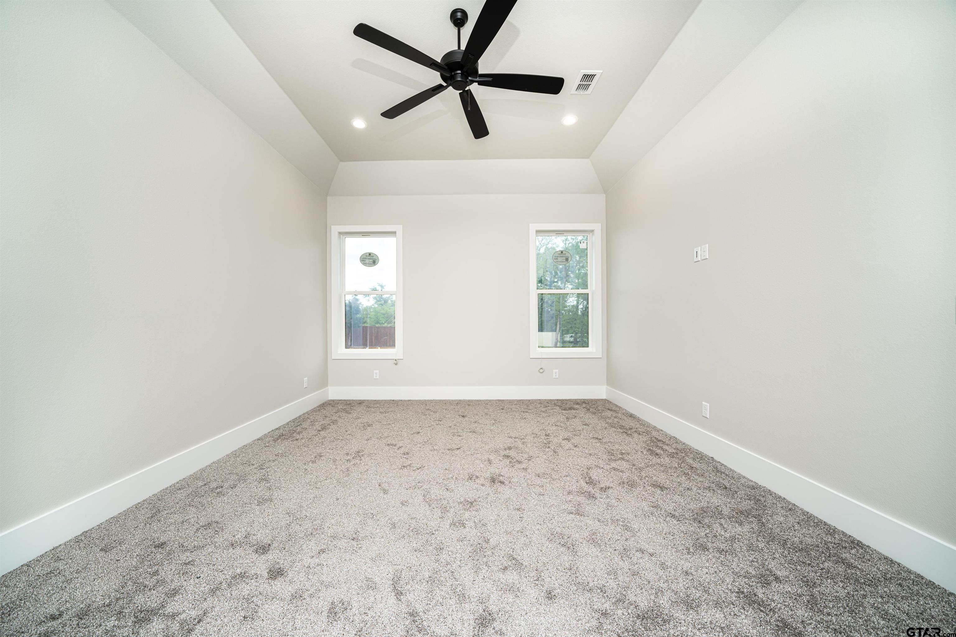 3910 Hidden Hills Circle Longview, TX 75605 - Photo 30 of 39 an empty room with a window and a fan