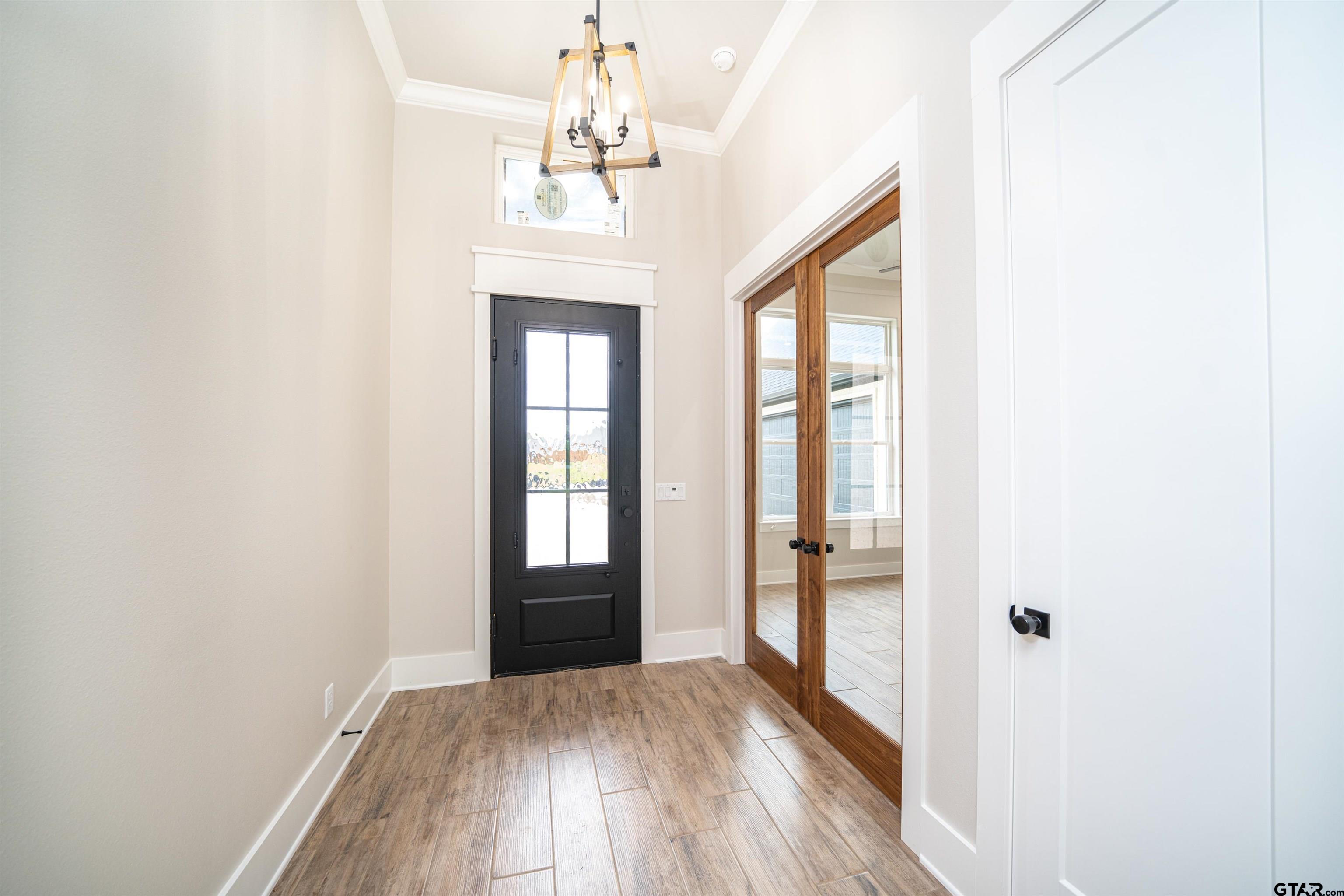 3910 Hidden Hills Circle Longview, TX 75605 - Photo 3 of 39 wooden floor in an empty room with a window