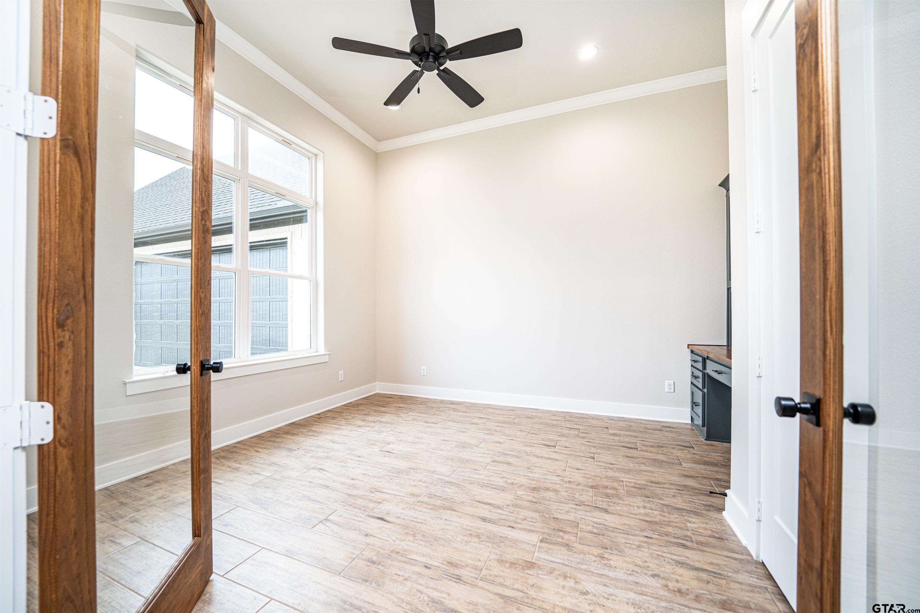 3910 Hidden Hills Circle Longview, TX 75605 - Photo 4 of 39 a view of empty room with wooden floor and fan