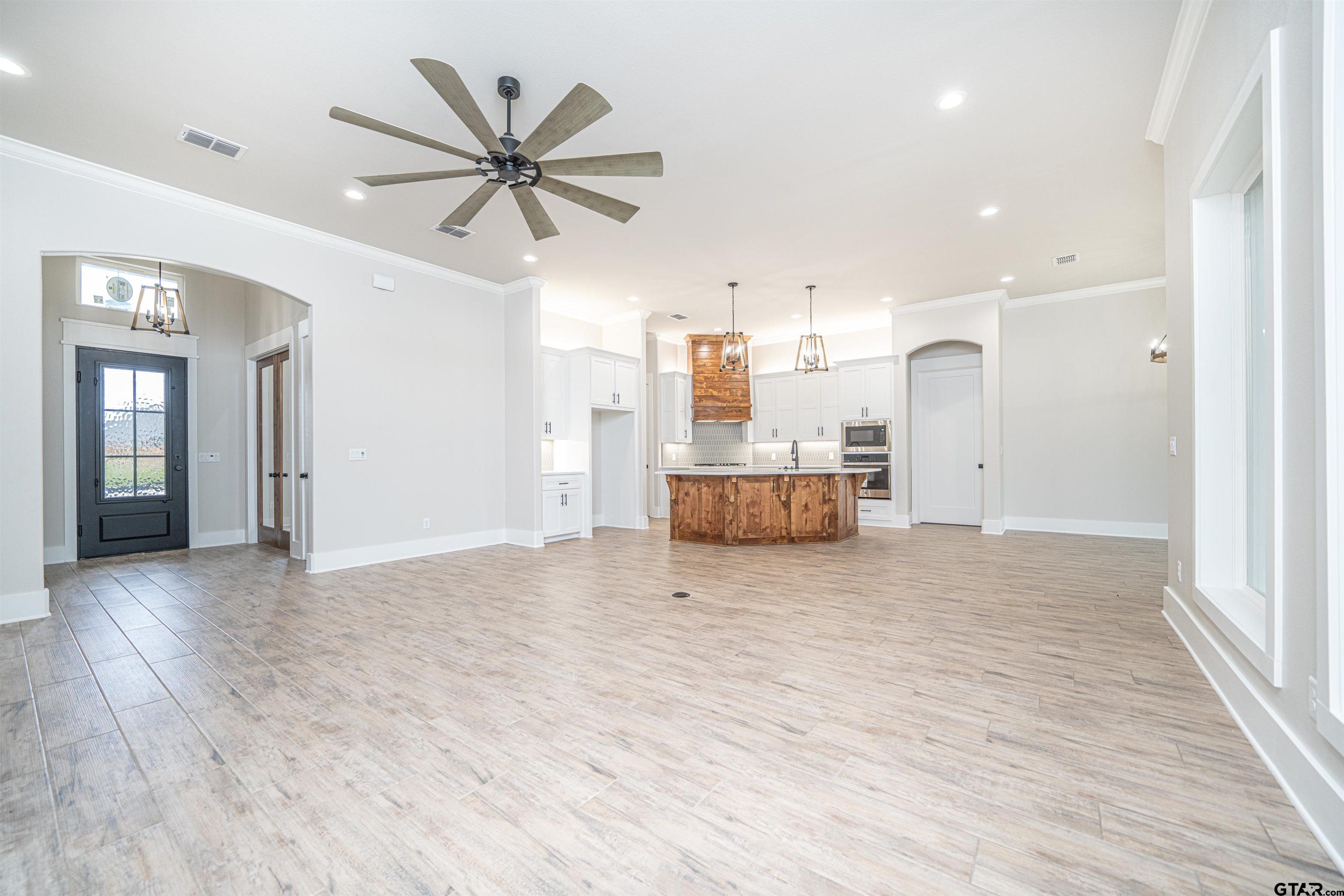 3910 Hidden Hills Circle Longview, TX 75605 - Photo 6 of 39 a view of a livingroom with a kitchen and wooden floor